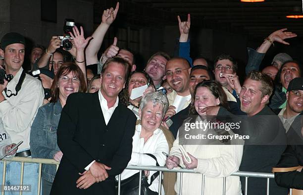 Kiefer Sutherland signing autographs and posing with fans outside the party.