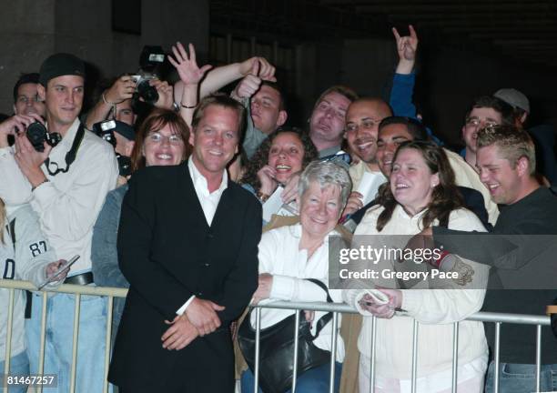 Kiefer Sutherland signing autographs and posing with fans outside the party.