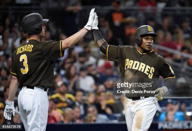 Erick Aybar of the San Diego Padres, right, is congratulated by Clayton Richard after scoring during the fourth inning of a baseball game against the...