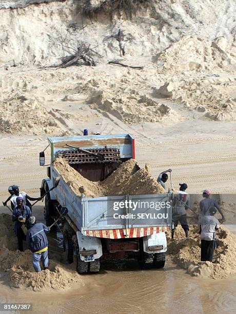 Trucks load sea sand, on April 26 near the quarry of Mbeubeuss, the only place on the coast where it is not illegal to remove the sand. The sand...