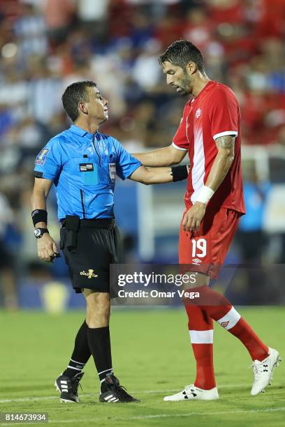 Steven Vitoria of Canada and Referee Joel Aguilar talk during the CONCACAF Gold Cup Group A match between Canada and Honduras at Toyota Stadium on...