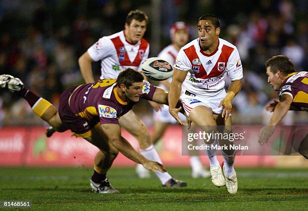 Rangi Chase of the Dragons offloads during the round 13 NRL match between the St George Illawarra Dragons and the Brisbane Broncos at WIN Stadium on...