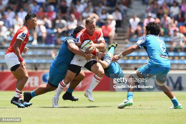 Riaan Viljoen of the Sunwolves is tackled during the Super Rugby match between the Sunwolves and the Blues at Prince Chichibu Stadium on July 15,...