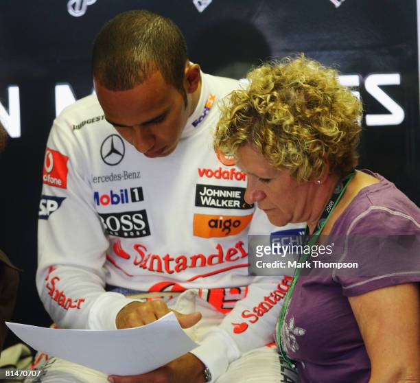 Lewis Hamilton of Great Britain and McLaren Mercedes is seen in his team garage with his mother Carmen Lockhart during practice for the Canadian...