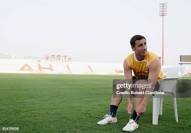 Scott McDonald of Australia ties up his boots prior to the start of the Australian Socceroos training session held at the Rashid Stadium on June 6,...