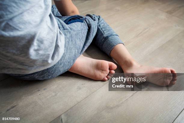 little boy sitting on the floor - unrecognizable person stock pictures, royalty-free photos & images
