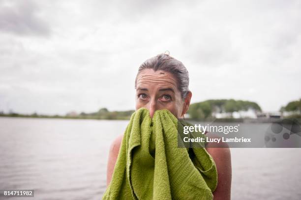 mature woman after swimming in open water - persistence stock pictures, royalty-free photos & images