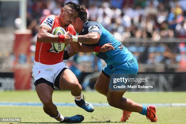 Fumiaki Tanaka of the Sunwolves is tackled by Augustine Pulu of the Blues during the Super Rugby match between the Sunwolves and the Blues at Prince...