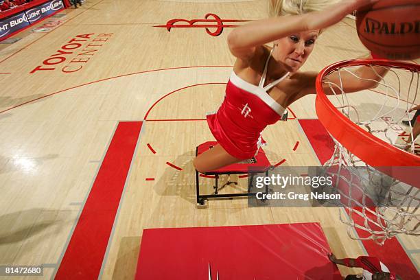 Basketball: Aerial view of Houston Rockets dance team cheerleader making dunk from trampoline during game vs Washington Wizards, Houston, TX 2/26/2008