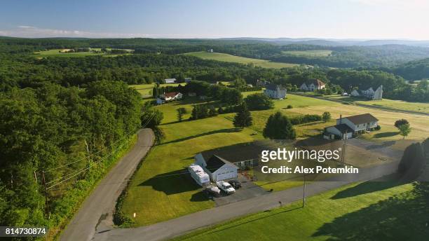 the scenery aerial view of poconos, monroe county, pennsylvania. the sunny summer morning. the panoramic overview over the field and forest to the kunkletown, then to the small farm near by the road. - pennsylvania stock pictures, royalty-free photos & images