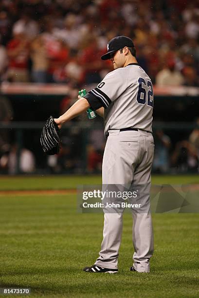 Baseball: ALDS Playoffs, New York Yankees Joba Chamberlain spraying himself with insect repellent during Game 2 vs Cleveland Indians, Cleveland, OH...