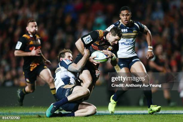 Stephen Donald of the Chiefs is tackled by Andrew Smith of the Brumbies during the round 17 Super Rugby match between the Chiefs and the Brumbies at...