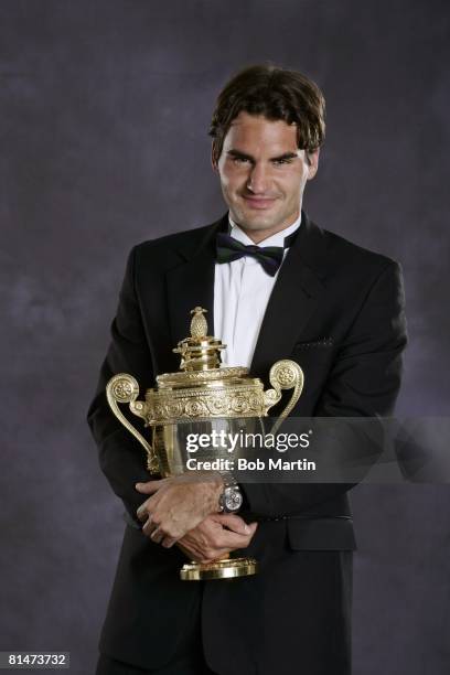 Tennis: Wimbledon, Formal portrait of Switzerland Roger Federer with Gentlemen's Singles trophy during Champions' Dinner at The Savoy Hotel, London,...