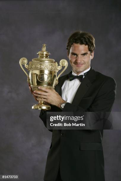 Tennis: Wimbledon, Formal portrait of Switzerland Roger Federer with Gentlemen's Singles trophy during Champions' Dinner at The Savoy Hotel, London,...