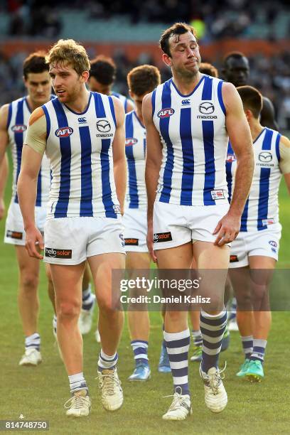 Daniel Nielson and Todd Goldstein of the Kangaroos walk from the field looking dejected after being defeated by the Power during the round 17 AFL...