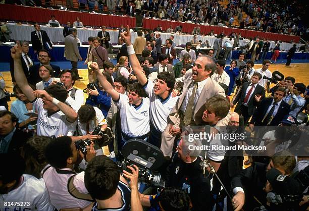 College Basketball: NCAA Final Four, Villanova coach Rollie Massimino victorious, getting carried off court by team after winning championship game...