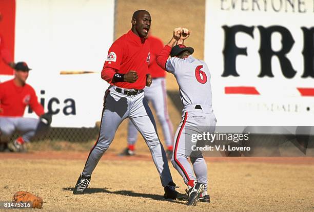 Baseball: Former basketball player Scottsdale Scorpions Michael Jordan play fighting with teammate during practice, Scottsdale, AZ