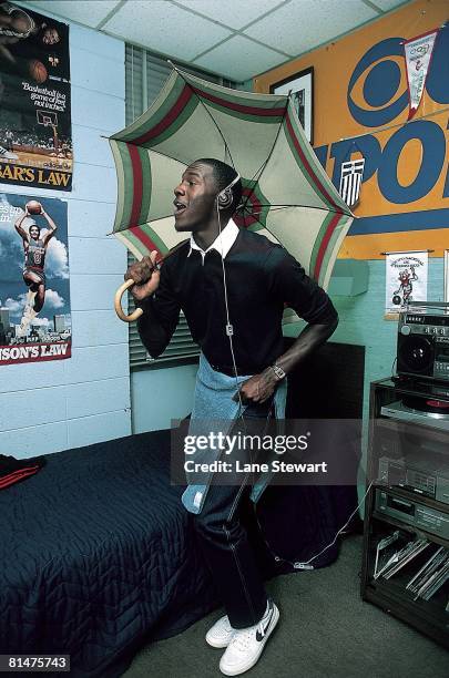 College Basketball: Casual portrait of North Carolina Michael Jordan dancing with umbrella in dorm room at University of North Carolina campus,...