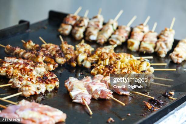 chicken skewers being cooked on teppan hot plate - griddle stock pictures, royalty-free photos & images