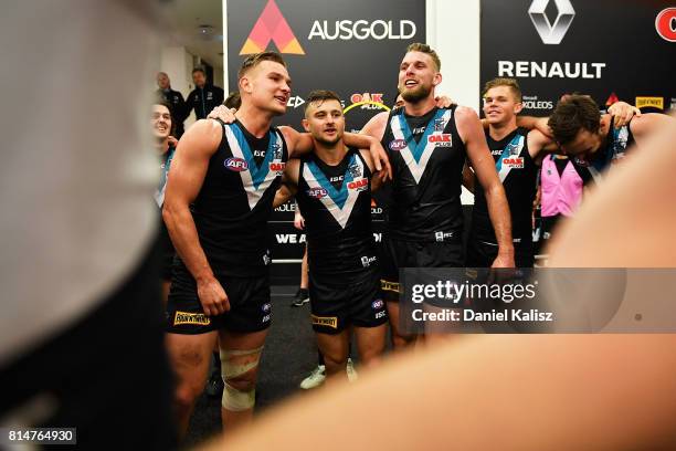 Ollie Wines, Sam Gray and Jackson Trengove of the Power sing the club song after the round 17 AFL match between the Port Adelaide Power and the North...