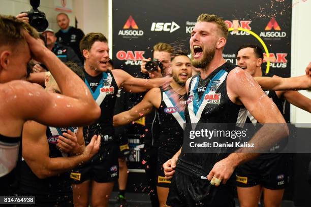 Jackson Trengove of the Power sings the club song after the round 17 AFL match between the Port Adelaide Power and the North Melbourne Kangaroos at...