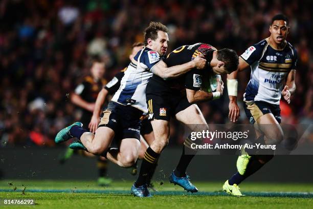 Ryan Lonergan of the Brumbies makes a tackle on Stephen Donald of the Chiefs during the round 17 Super Rugby match between the Chiefs and the...