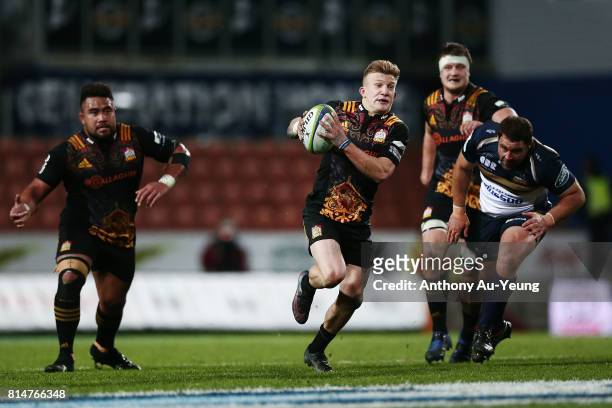 Damian McKenzie of the Chiefs makes a break during the round 17 Super Rugby match between the Chiefs and the Brumbies at Waikato Stadium on July 15,...