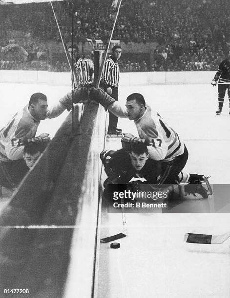 Canadian ice hockey player Jean-Guy Talbot of the Montreal Canadiens takes down Ted Hampson of the New York Rangers during a game, February 11, 1962.