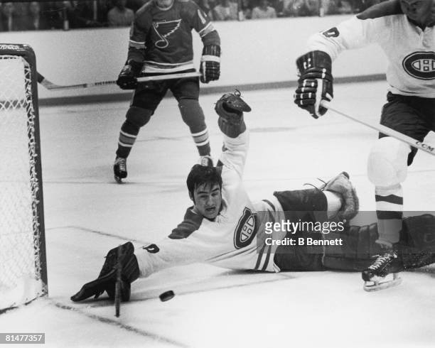 Canadian ice hockey player Rogatien Vachon , goalkeeper for the Montreal Canadiens, goes to the ice as he tries to stop a goal during a game against...
