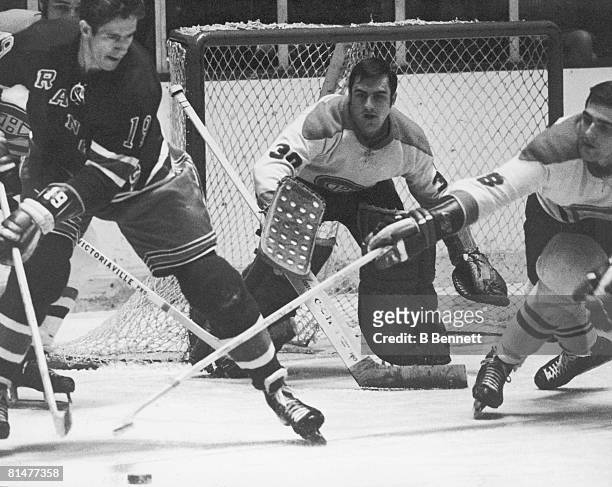 Canadian ice hockey player Rogatien Vachon , goalkeeper for the Montreal Canadiens, keeps his eyes on the puck in front of his net during a game...