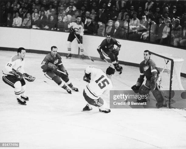 Canadian ice hockey player Bobby Rousseau of Montreal Canadiens fires a shot from close range as Roger Crozier, goalkeeper for the Detroit Red Wings,...