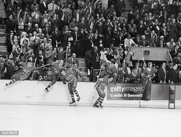 The Montreal Canadiens leap over the boards in celebration after they defeated the St. Louis Blues in the last game of the Stanley Cup finals,...