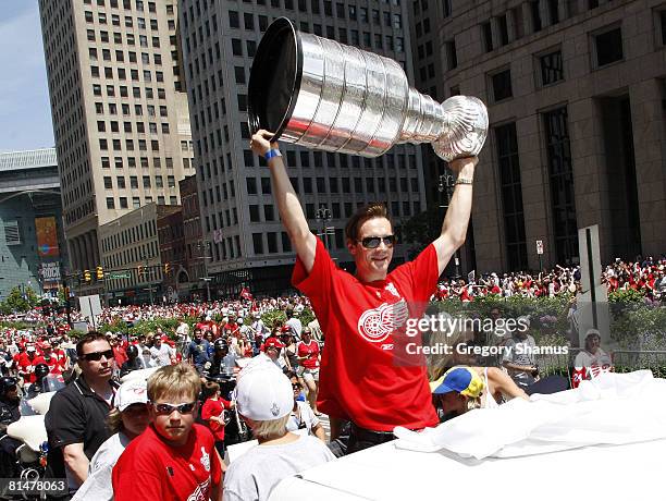 Nicklas Lidstrom of the Detroit Red Wings holds up the Stanley Cup during a parade to celebrate winning the 2008 Stanley Cup on June 6, 2008 in...