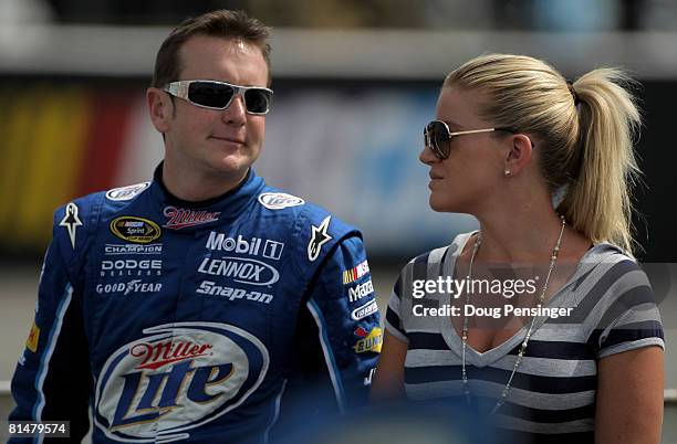 Kurt Busch, driver of the Miller Lite Dodge, and his wife Eva Busch talk during qualifying for the NASCAR Sprint Cup Series Pocono 500 on June 6,...