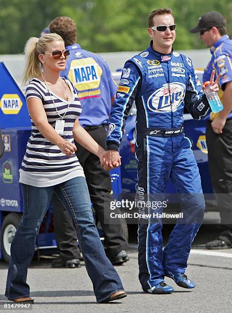 Kurt Busch, driver of the Miller Lite Dodge, walks along pit road with his wife Eva Busch during qualifying for the NASCAR Sprint Cup Series Pocono...