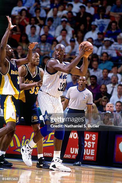 Shaquille O'Neal of the Orlando Magic posts up against Antonio Davis of the Indiana Pacers in Game One of the Eastern Conference Quarterfinals during...