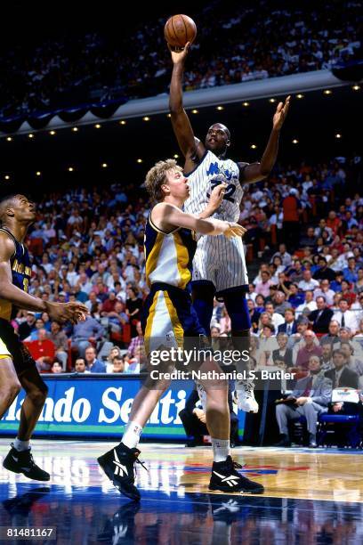 Shaquille O'Neal of the Orlando Magic shoots over Rick Smits of the Indiana Pacers in Game One of the Eastern Conference Quarterfinals during the...