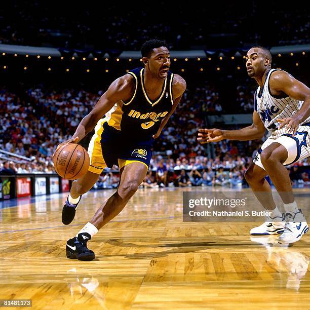 Sam Mitchell of the Indiana Pacers drives to the basket against Dennis Scott of the Orlando Magic in Game One of the Eastern Conference Quarterfinals...