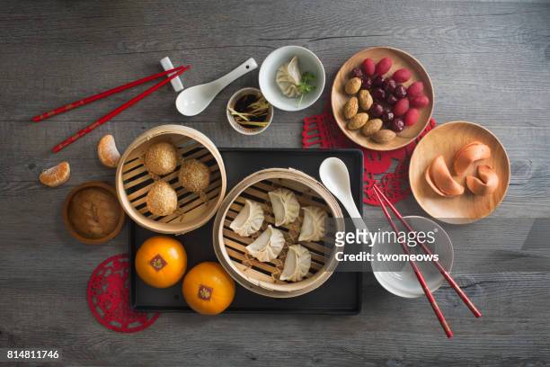 Chinese food steamed dumpling and tea served on rustic wooden background.