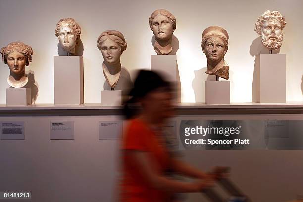 Women walk by Greek busts displayed in the antiquities section of the Metropolitan Museum of Art June 6, 2008 in New York City. Responding to...