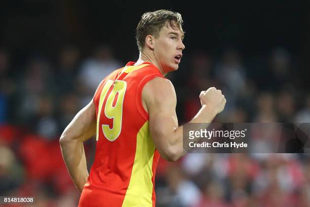 Tom Lynch of the Suns celebrates a goal during the round 17 AFL match between the Gold Coast Suns and the Collingwood Magpies at Metricon Stadium on...