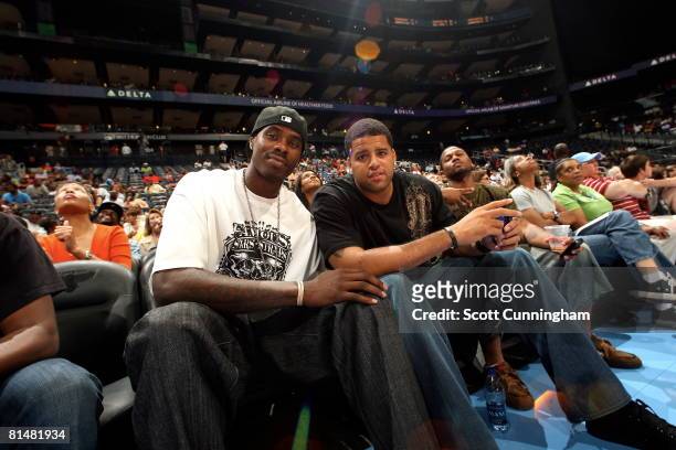 Marvin Williams of the Atlanta Hawks and Sean May of the Charlotte Bobcats watch the action between the Atlanta Dream and the Chicago Sky at Philips...