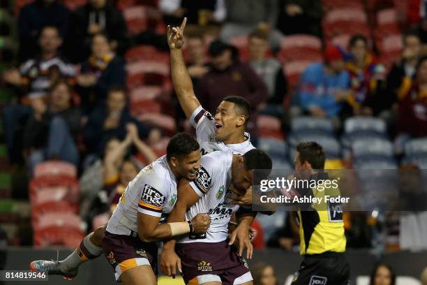 Tautau Moga of the Broncos celebrates his try with team mates during the round 19 NRL match between the Newcastle Knights and the Brisbane Broncos at...