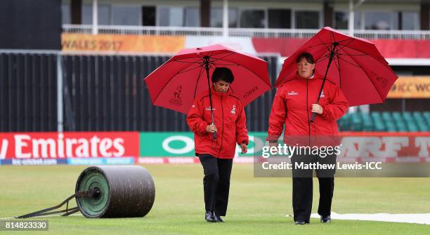 Umpires Kathy Cross and Sue Redfern inspect the outfield, as rain delays the start of play ahead of the ICC Women's World Cup 2017 match between...