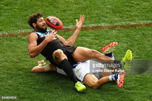 Patrick Ryder of the Power marks the ball over Lindsay Thomas of the Kangaroos during the round 17 AFL match between the Port Adelaide Power and the...