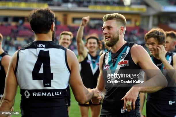 Jackson Trengove is congratulated by Patrick Ryder of the Power after the round 17 AFL match between the Port Adelaide Power and the North Melbourne...