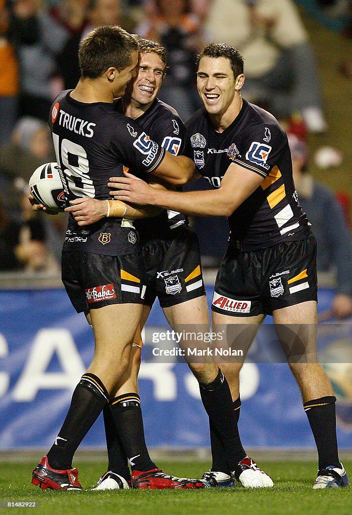 Nolan Stringer Beau Ryan and Dean Collis of the Tigers congratulate team-mate Brett ...