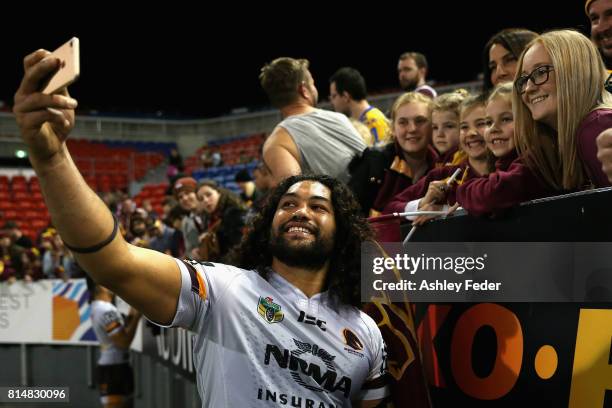 Adam Blair of the Broncos poses for a selfie with a fan during the round 19 NRL match between the Newcastle Knights and the Brisbane Broncos at...