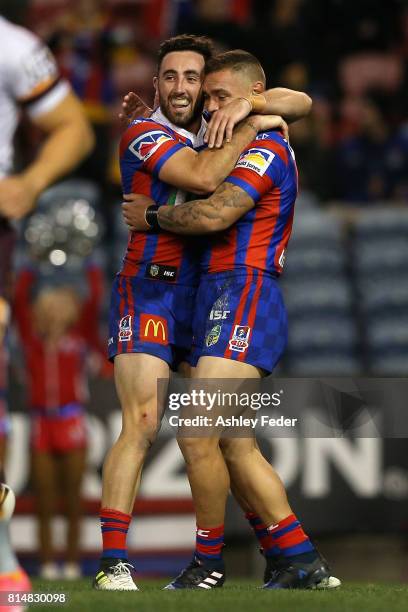 Danny Levi of the Knights celebrates his try with Brock Lamb during the round 19 NRL match between the Newcastle Knights and the Brisbane Broncos at...