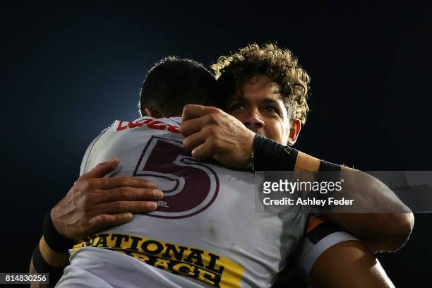 Dane Gagai of the Knights embraces Jonus Peterson of the Broncos during the round 19 NRL match between the Newcastle Knights and the Brisbane Broncos...